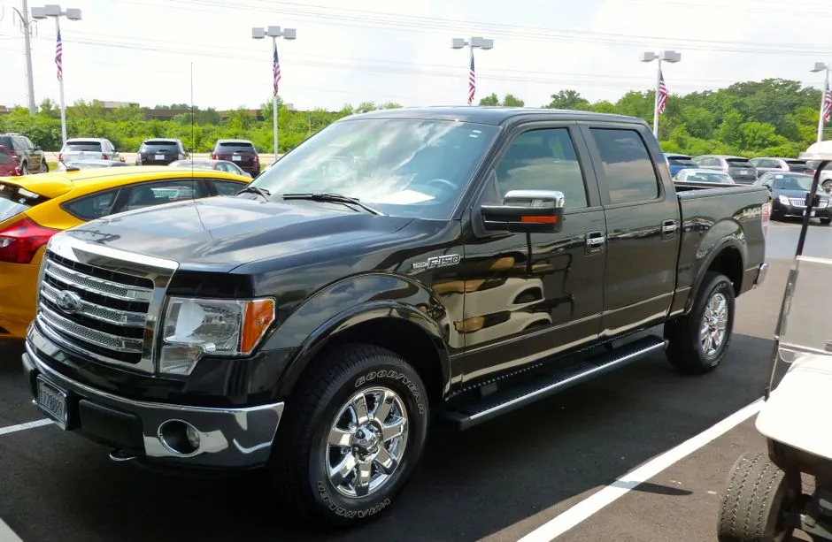A used pickup truck parked on a dealership lot, illustrative photo